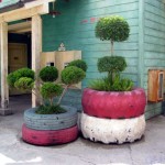 Plantenbakken van twee auto of trekker banden op elkaar gestapeld als plantenbak voor grote planten, op een terras.